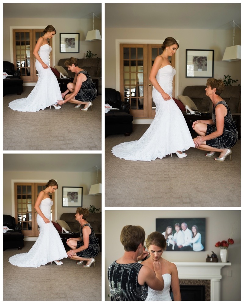 Bride's mother helps with her shoes.